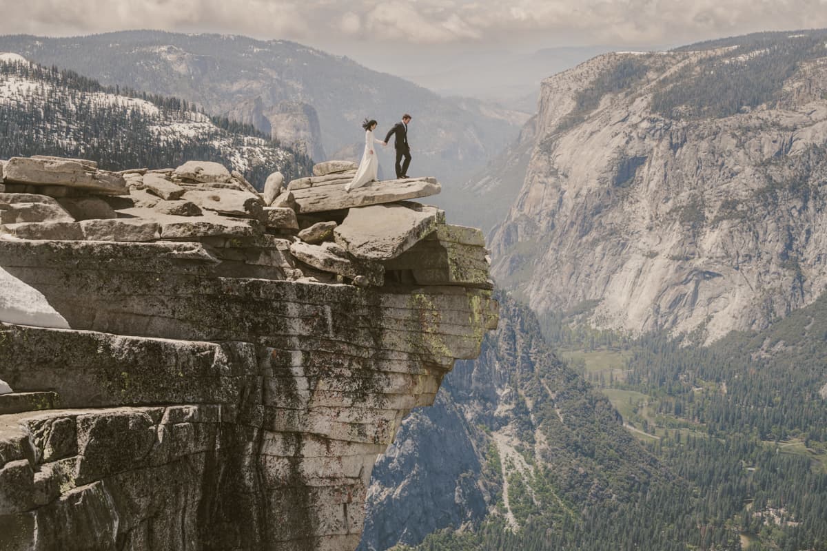 Yosemite adventure elopement couple on granite overlook at sunset