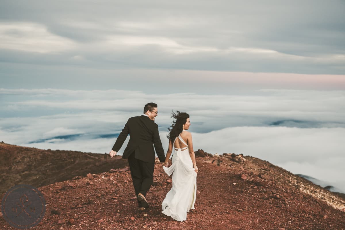 Hawaii adventure elopement couple on a cliffside with ocean and tropical landscape