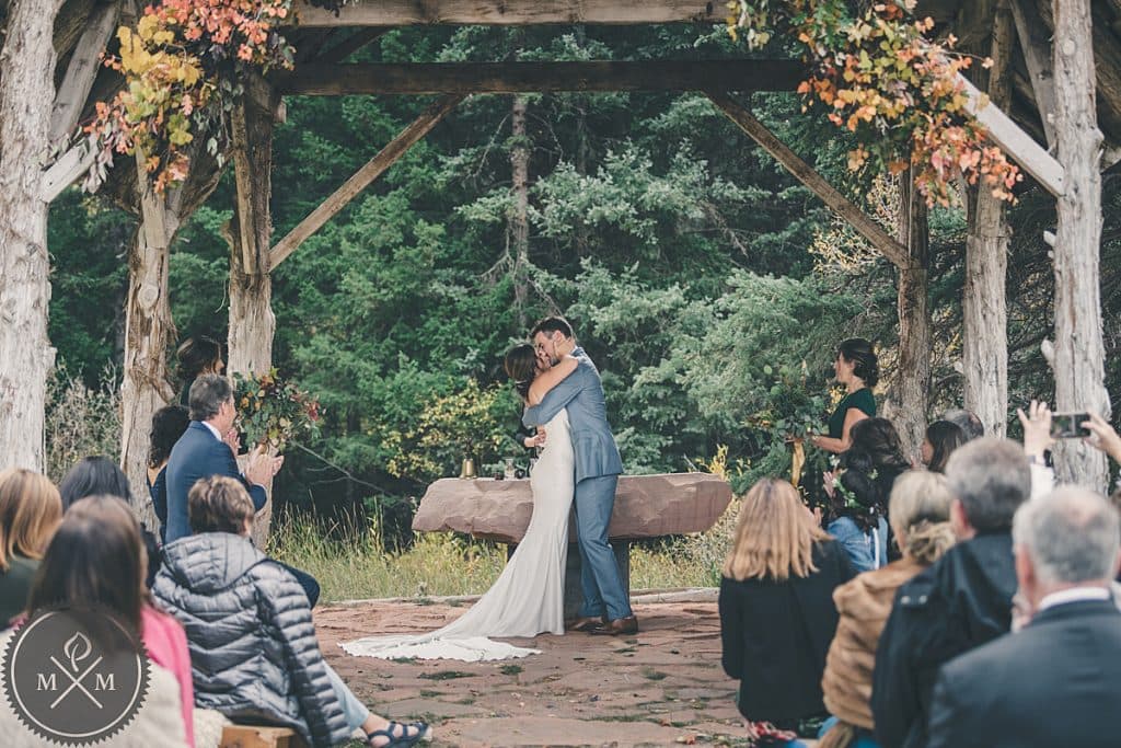 Wedding ceremony at Dunton Hot Springs Colorado with mountain and river backdrop
