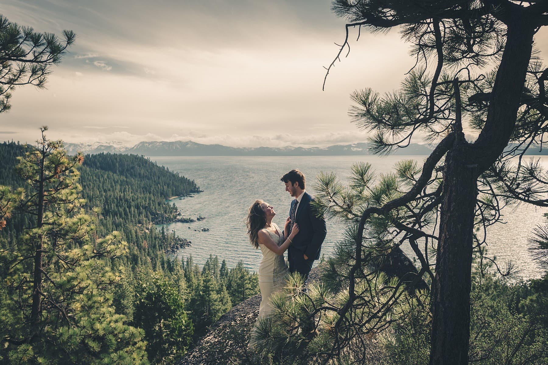 Lake Tahoe wedding couple at sunset with alpine lake and Sierra Nevada mountains