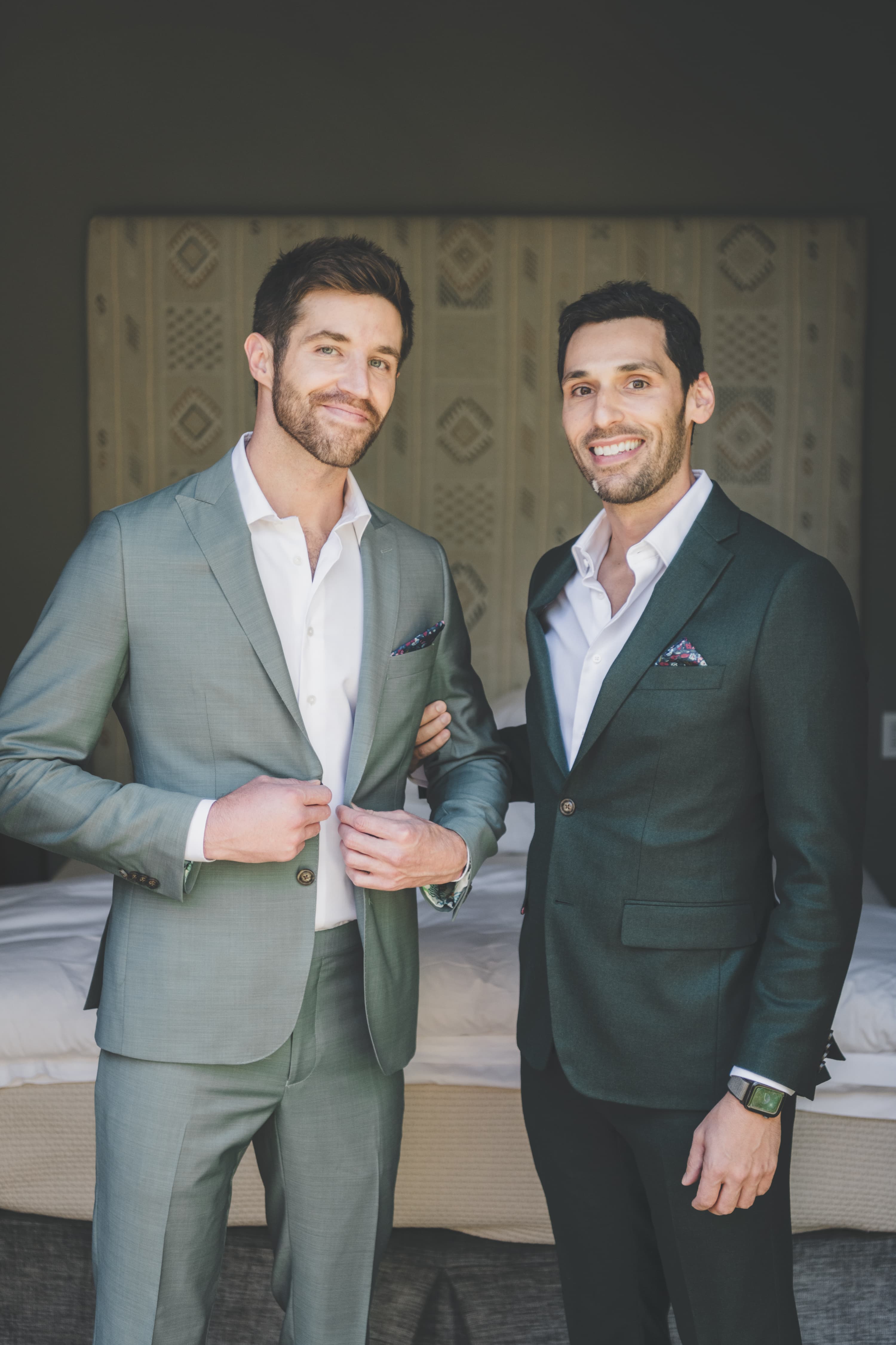 Greg and John portrait together in their wedding suits inside the bridal suite
