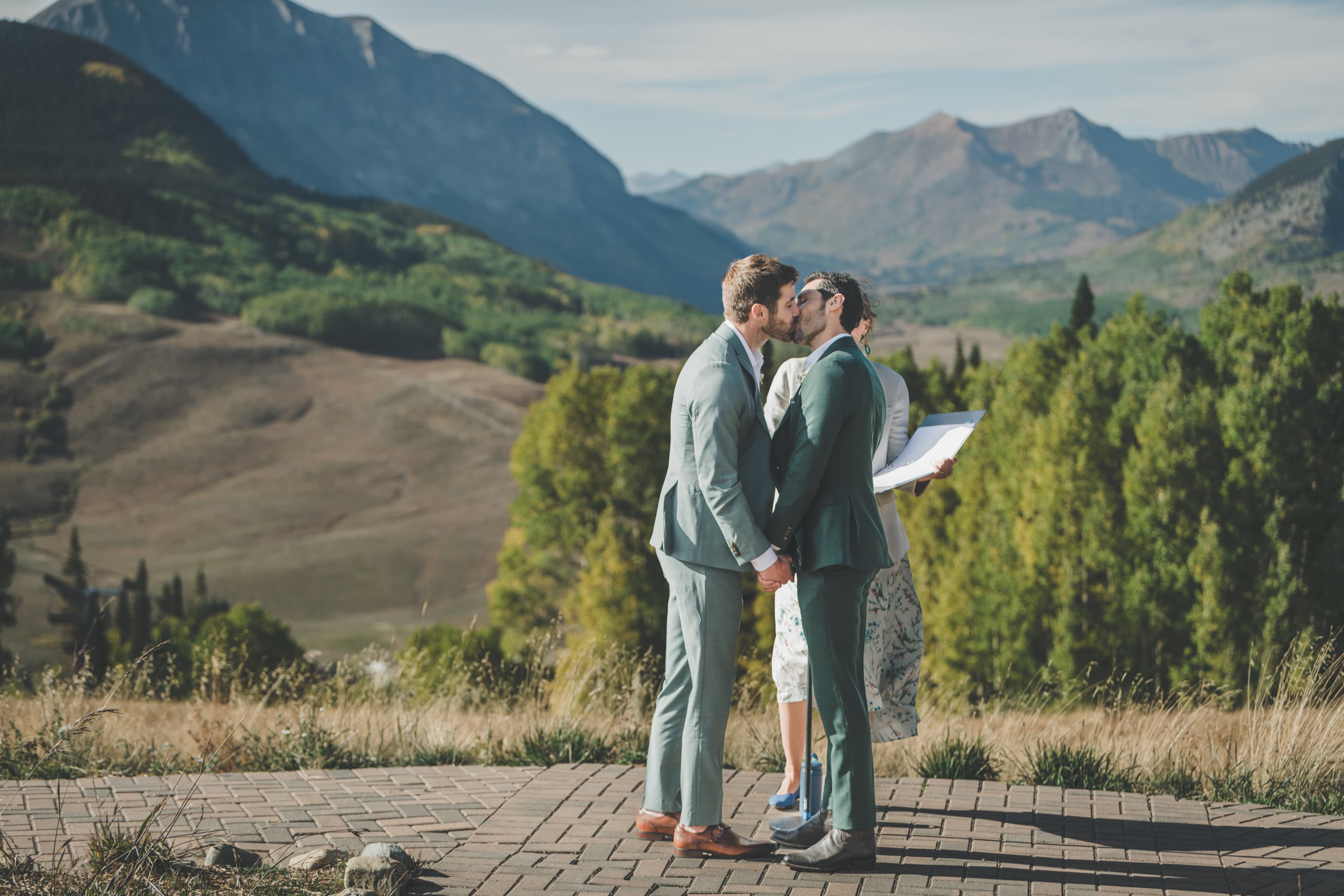 Greg and John's first kiss as a married couple with the Elk Mountains as backdrop