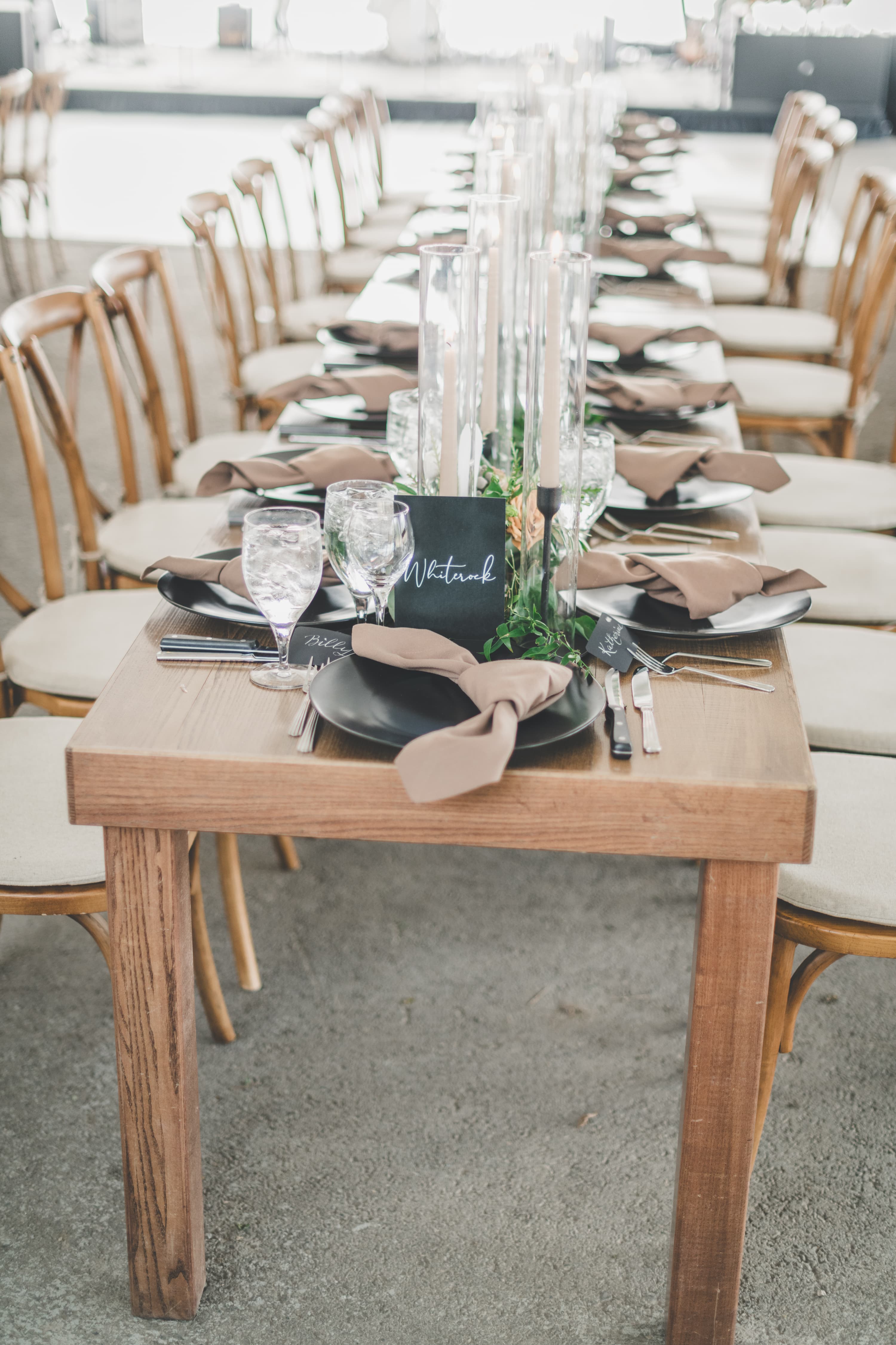 Long banquet table place setting at Greg and John's reception with candles and greenery runner