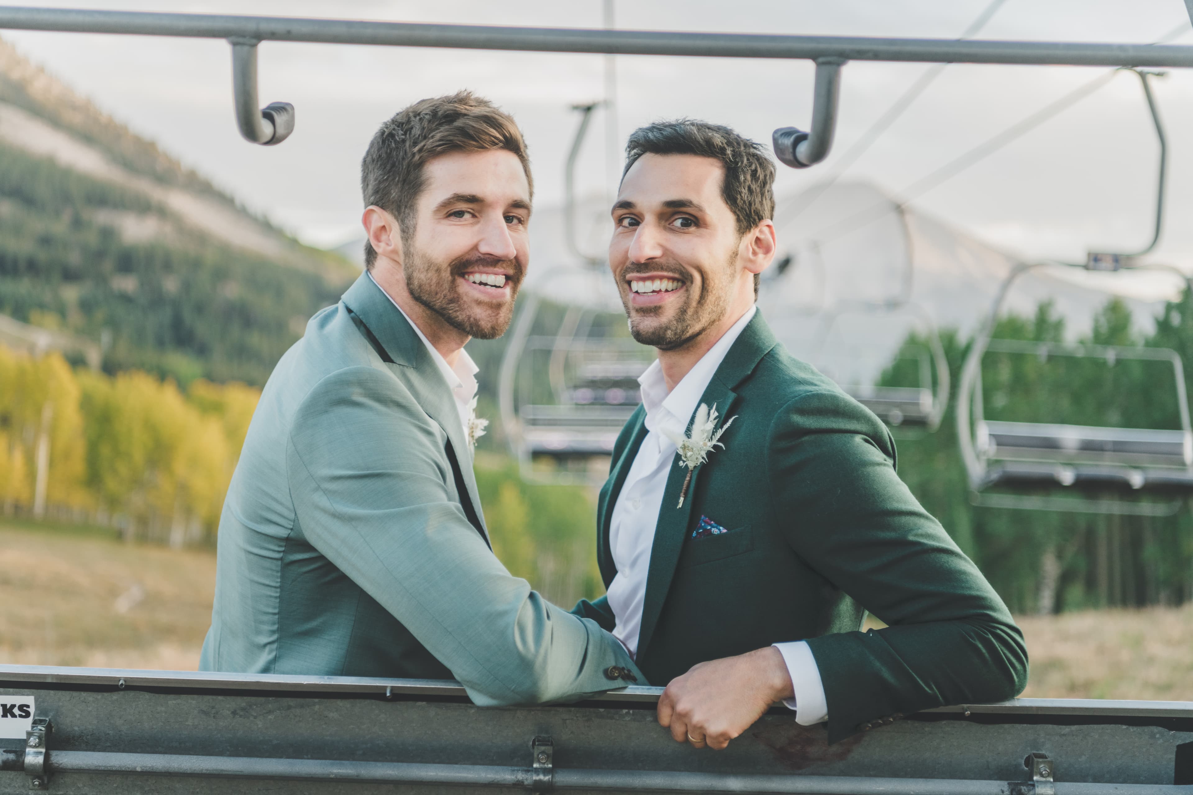 Greg and John smiling on the chairlift ride up to Ten Peaks Lodge