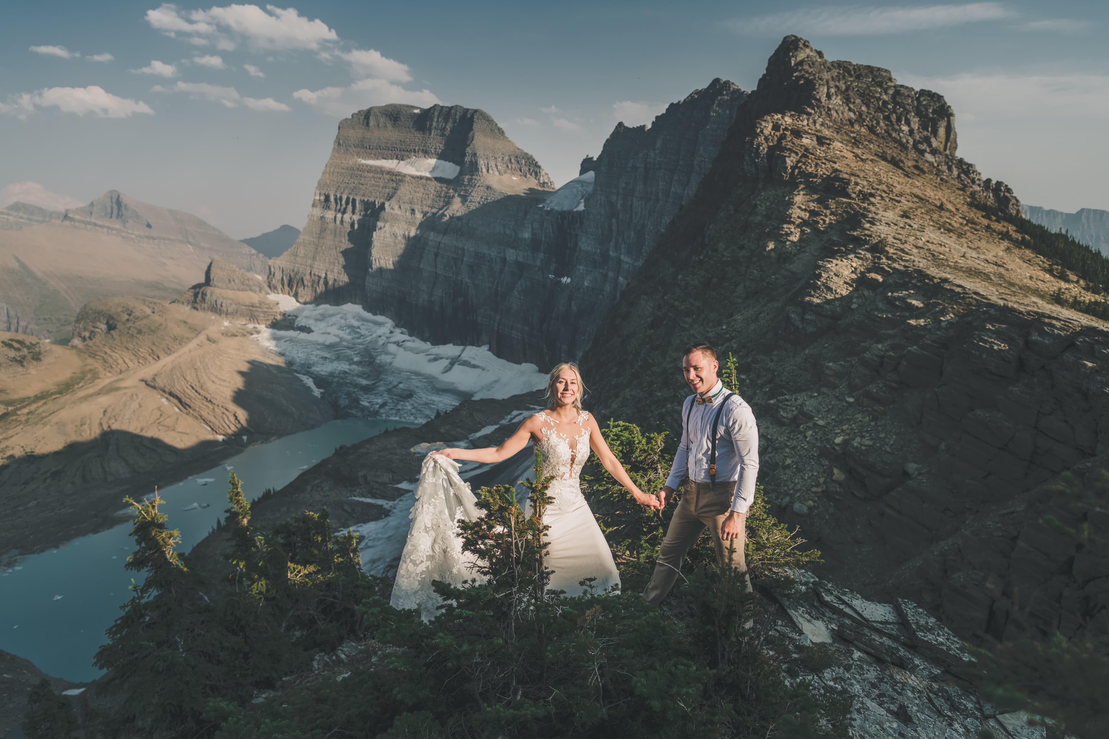 Shawna and Ryan on the rocky overlook with Grinnell Glacier and its turquoise meltwater lake spread below