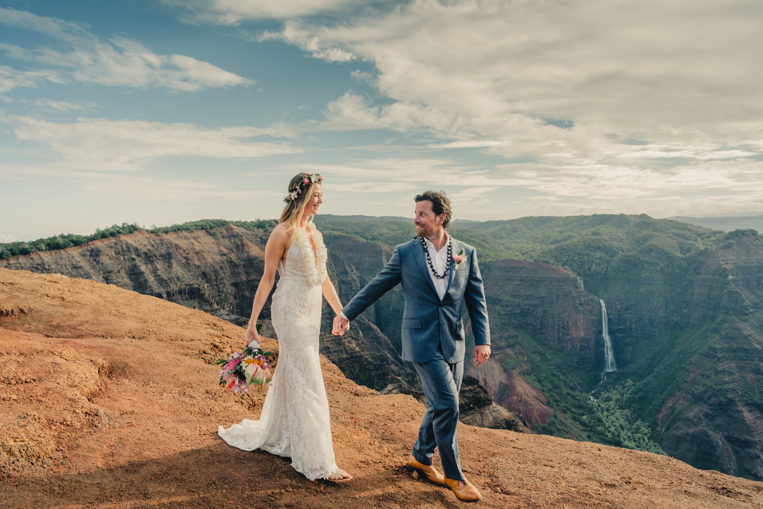 Erin and Kenny walking the ridge above Waimea Canyon, the Grand Canyon of the Pacific spread beyond
