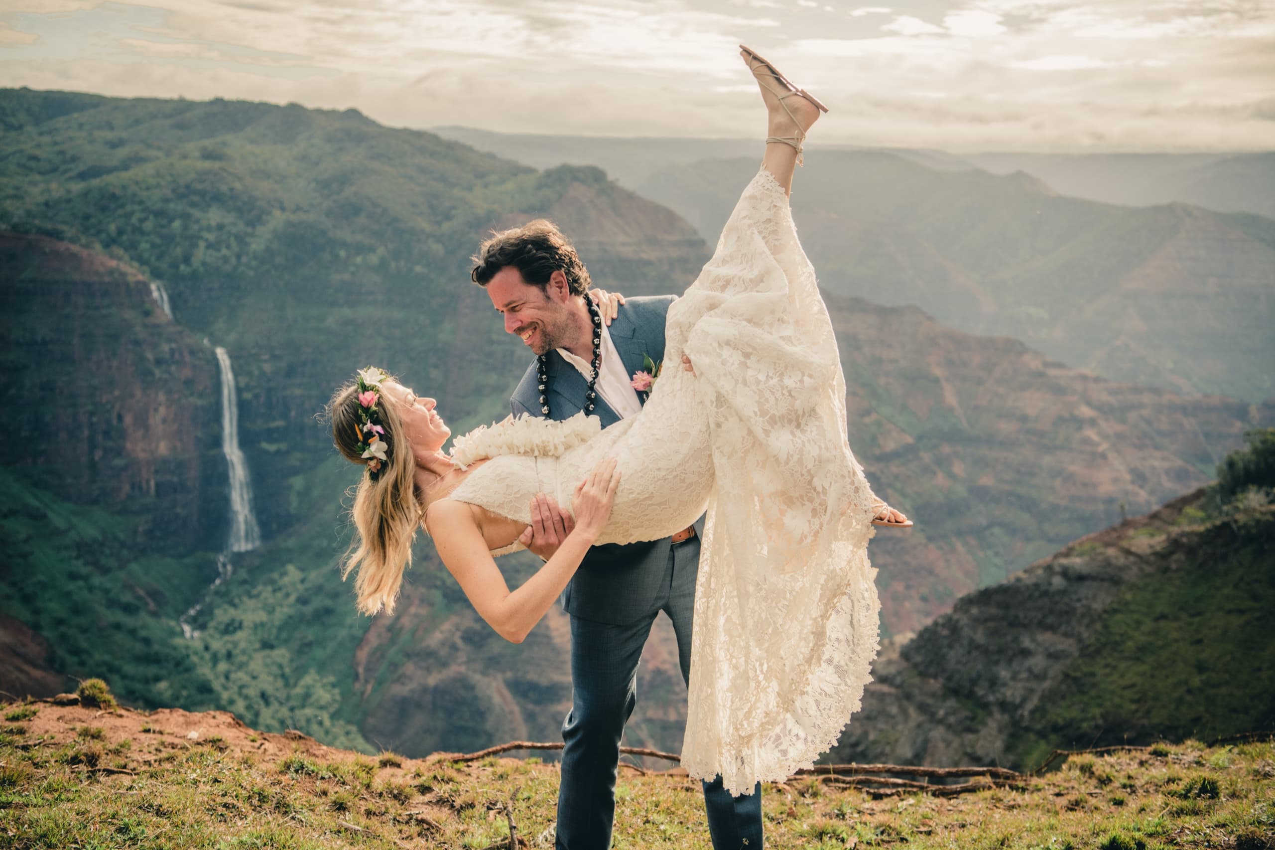 Kenny dips Erin at the canyon rim with Waipoo Falls in the frame and her dress flying