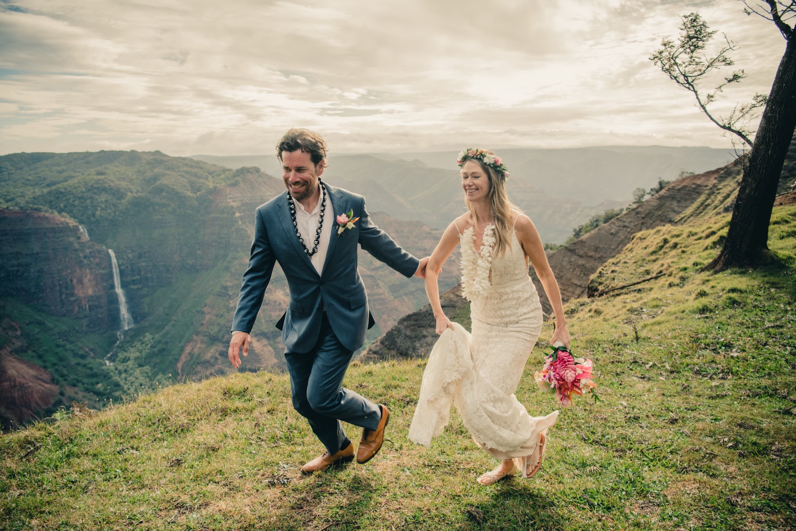 Erin and Kenny running hand-in-hand along the ridge above Waimea Canyon