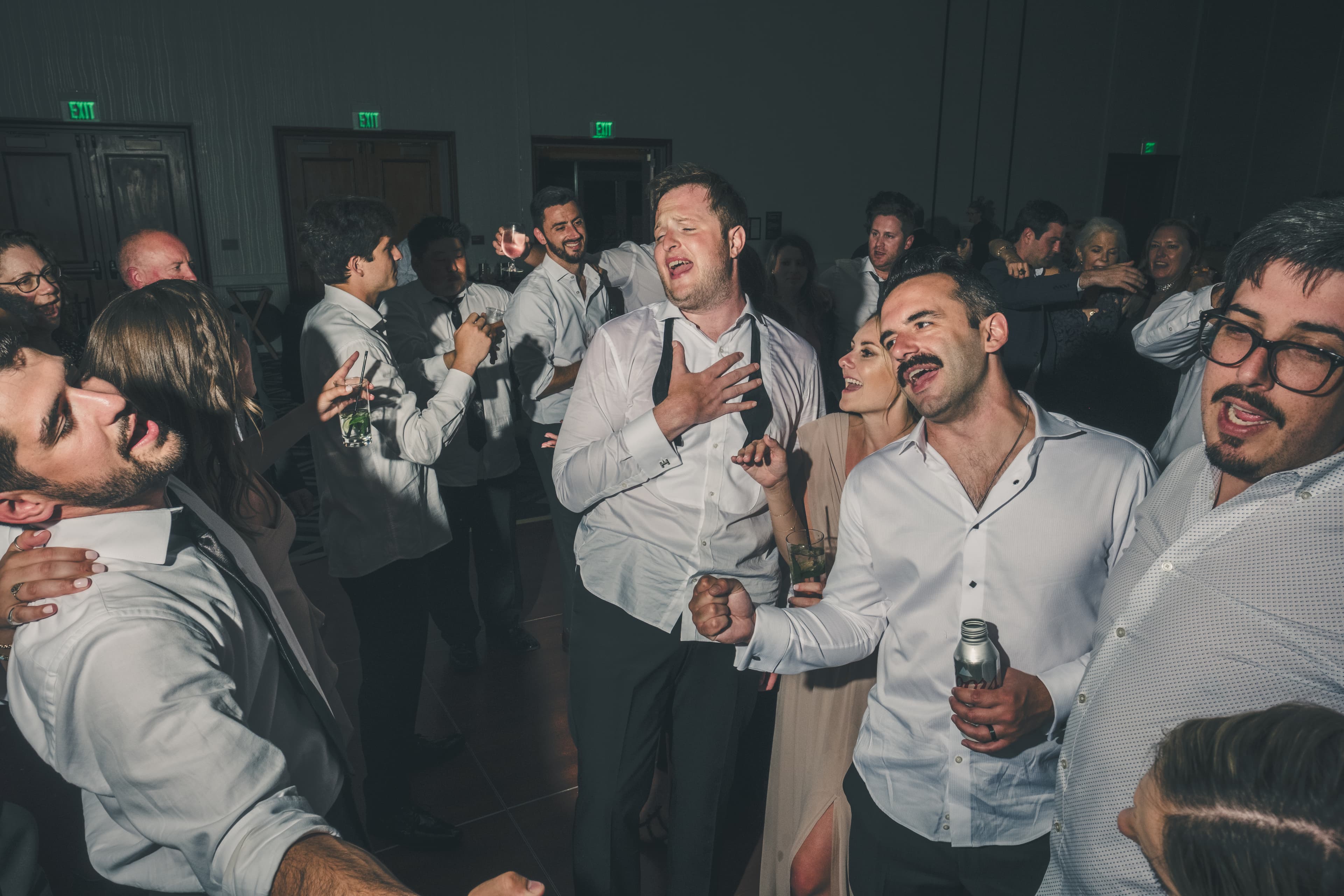 Will and friends mid-song on the dance floor at the Everline Resort reception
