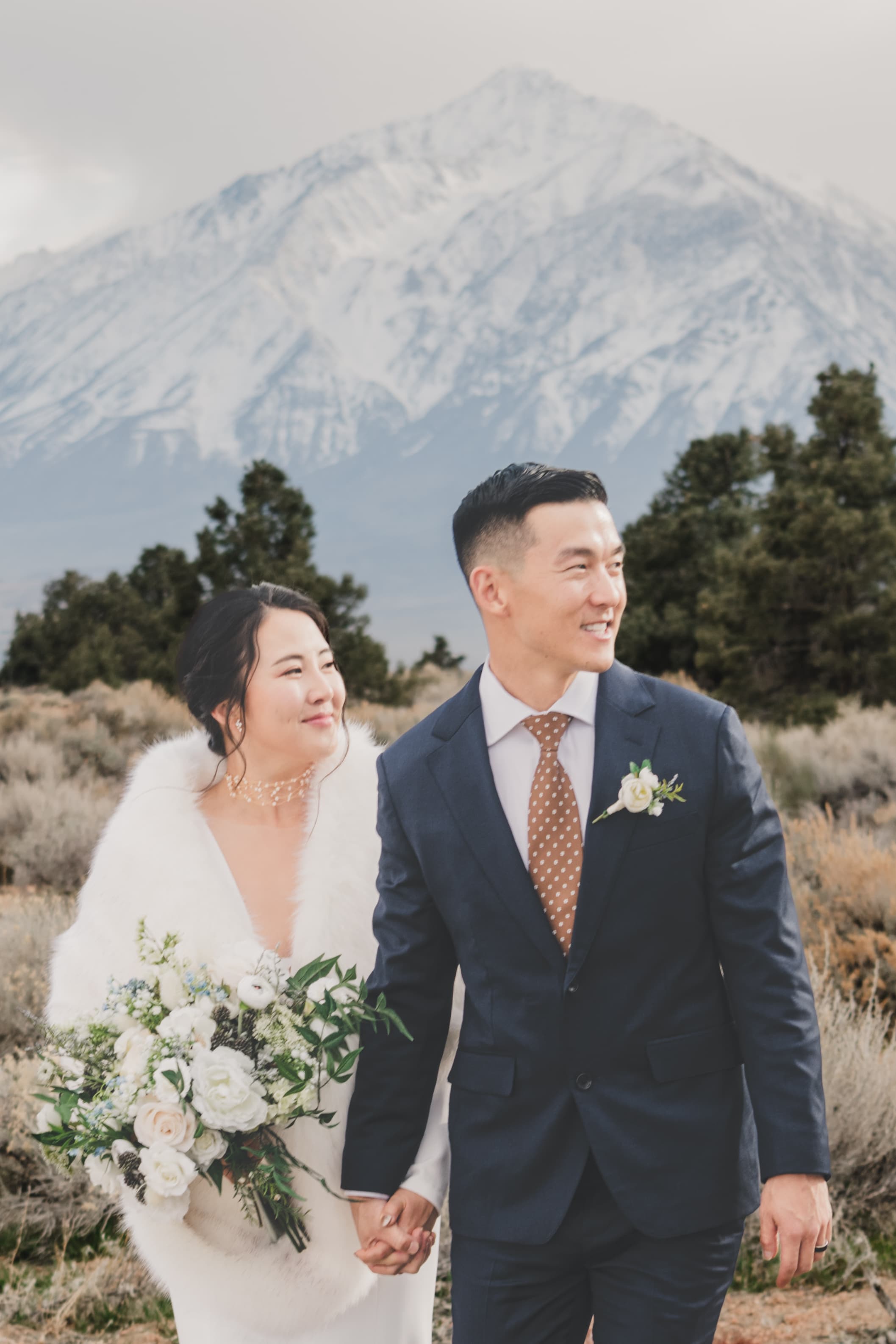 Hana and Chris Mammoth wedding — couple embracing with alpine scenery