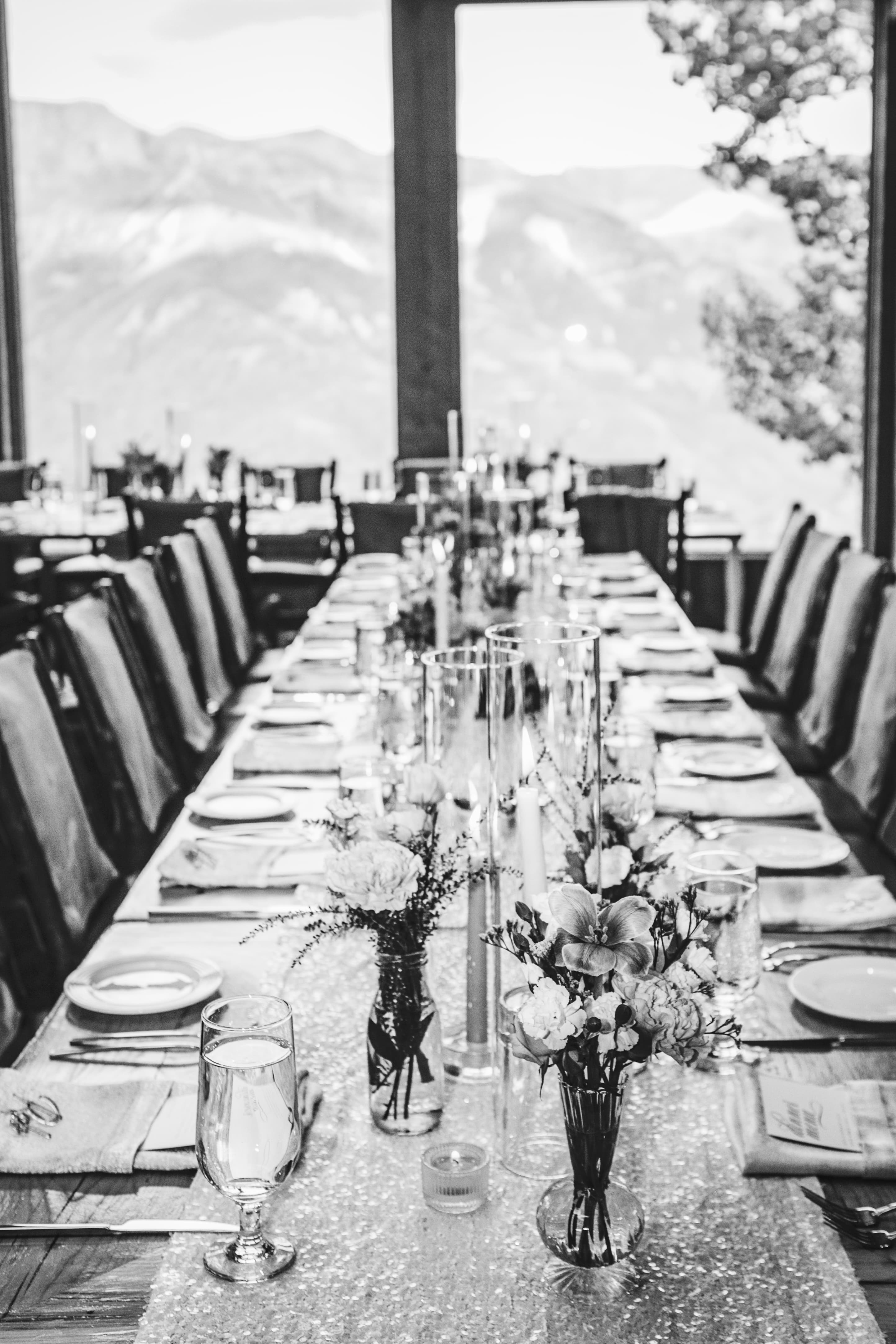 Allred's long banquet table set for Ben and Elizabeth's reception — San Juan Mountains through the full-height windows
