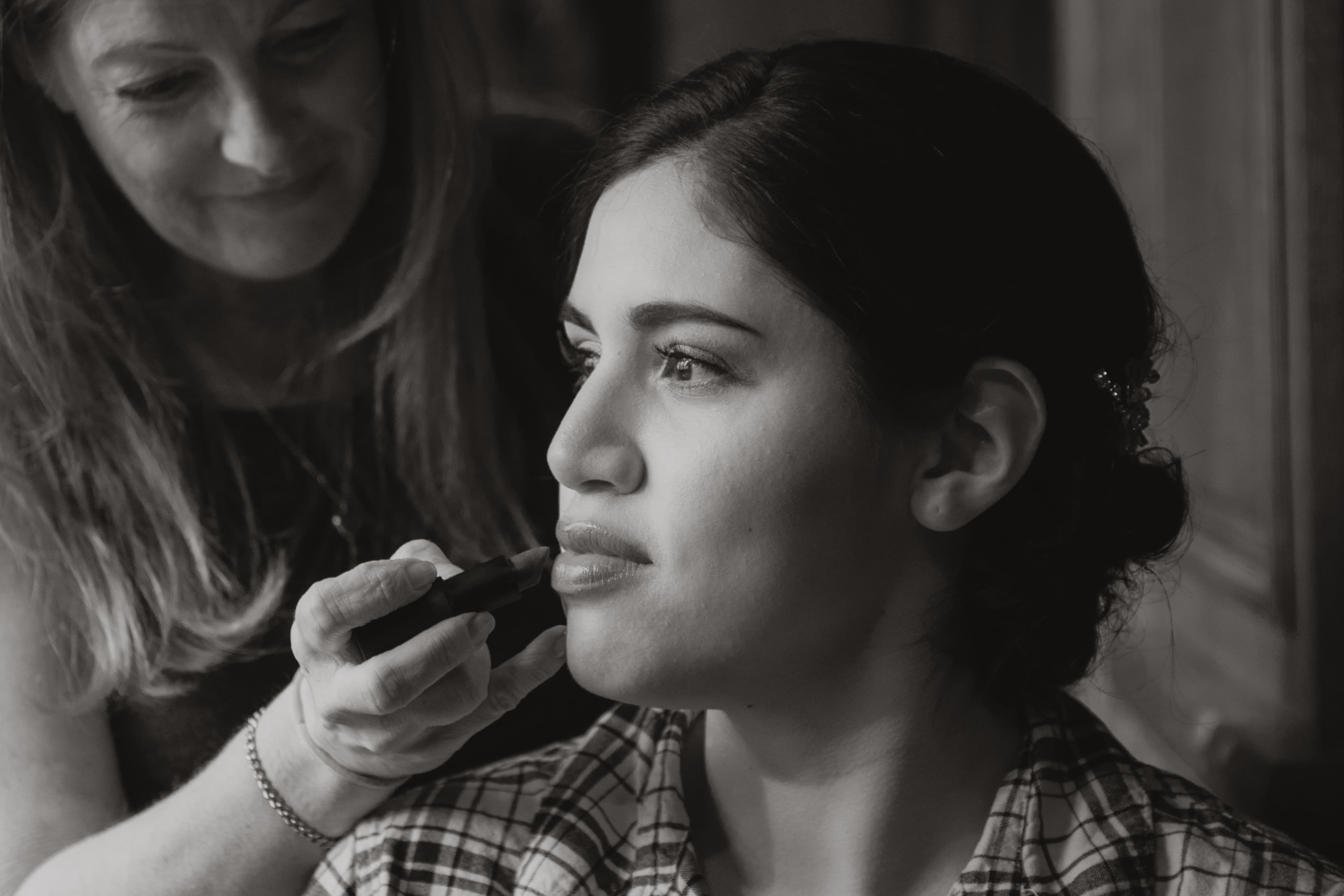 Sabrina getting ready — black-and-white portrait while makeup is applied before her Alpino Vino wedding