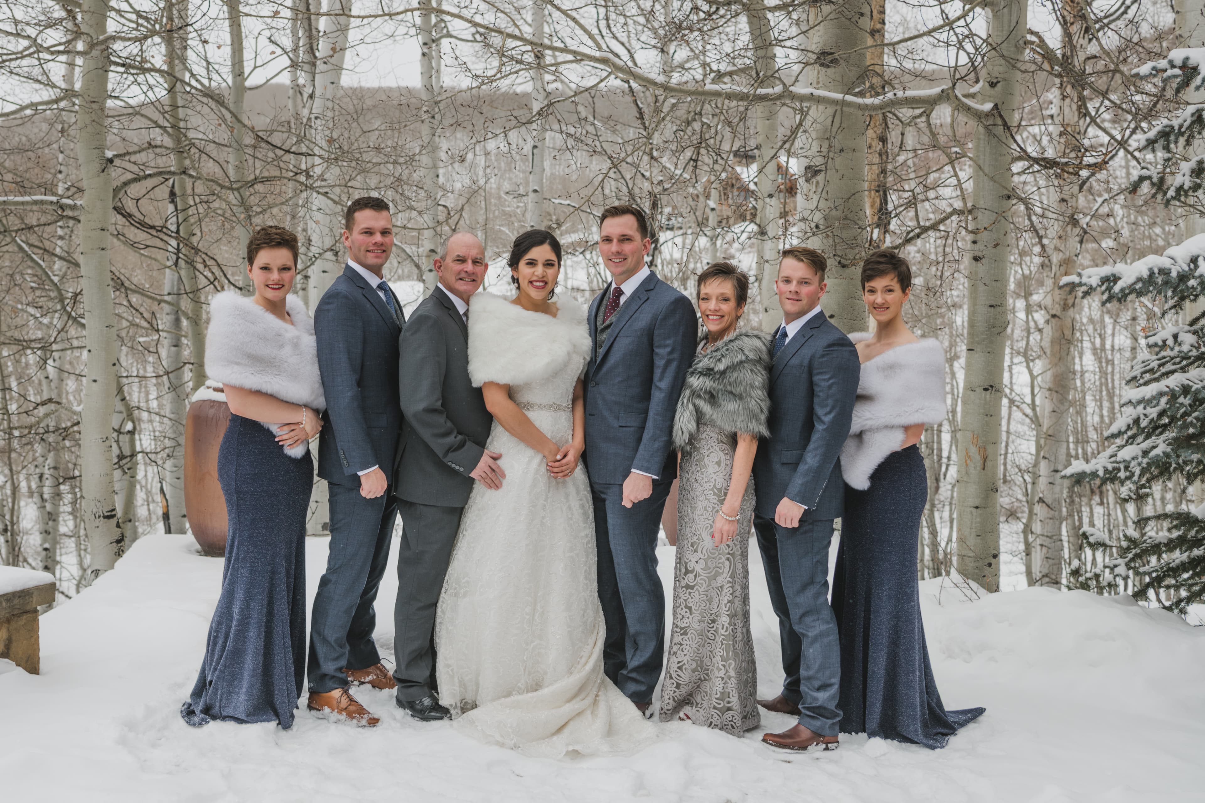 Sabrina and Patrick with their full bridal party in the snow under the Telluride aspens