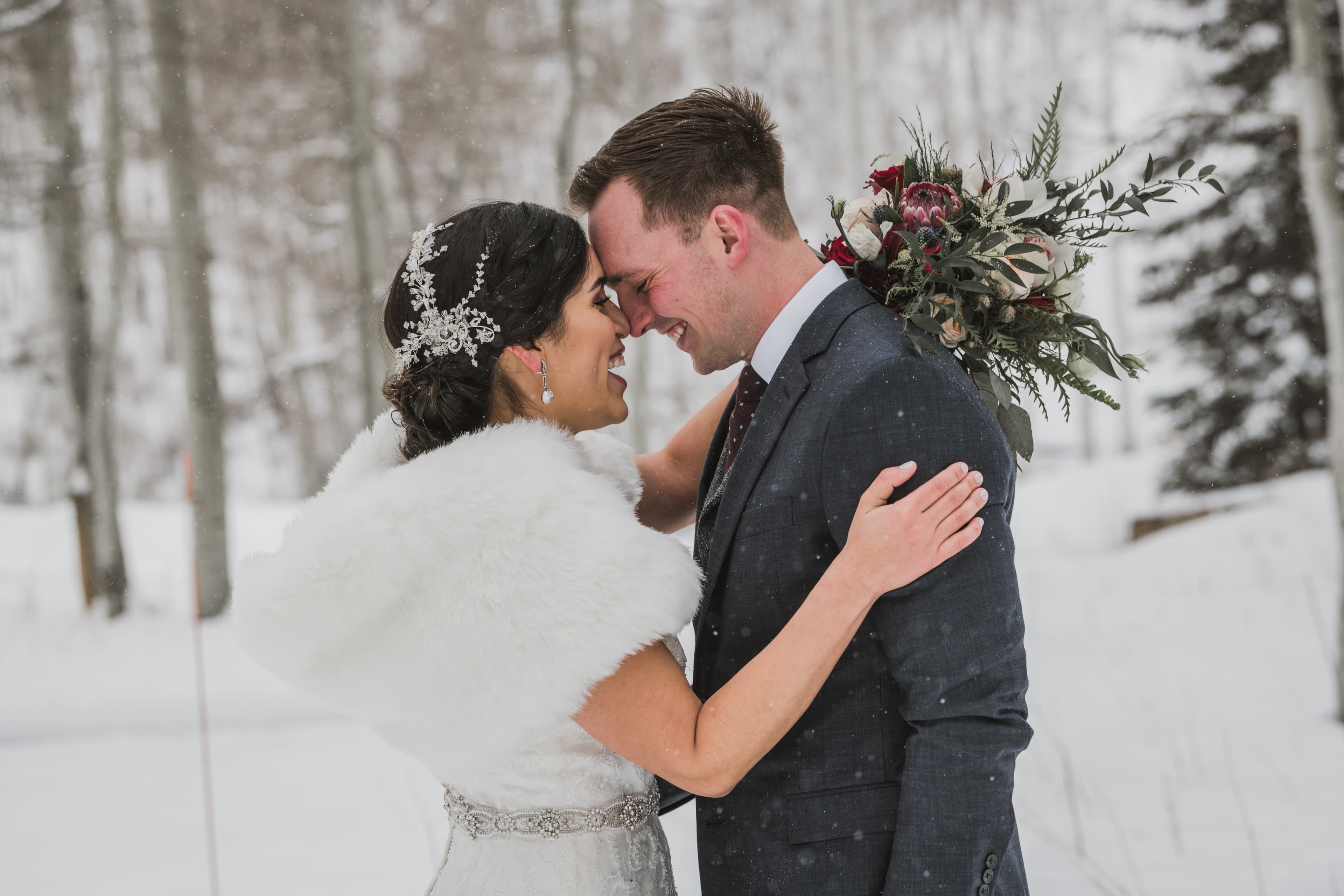 Sabrina and Patrick share a close moment as snow falls around them in Telluride