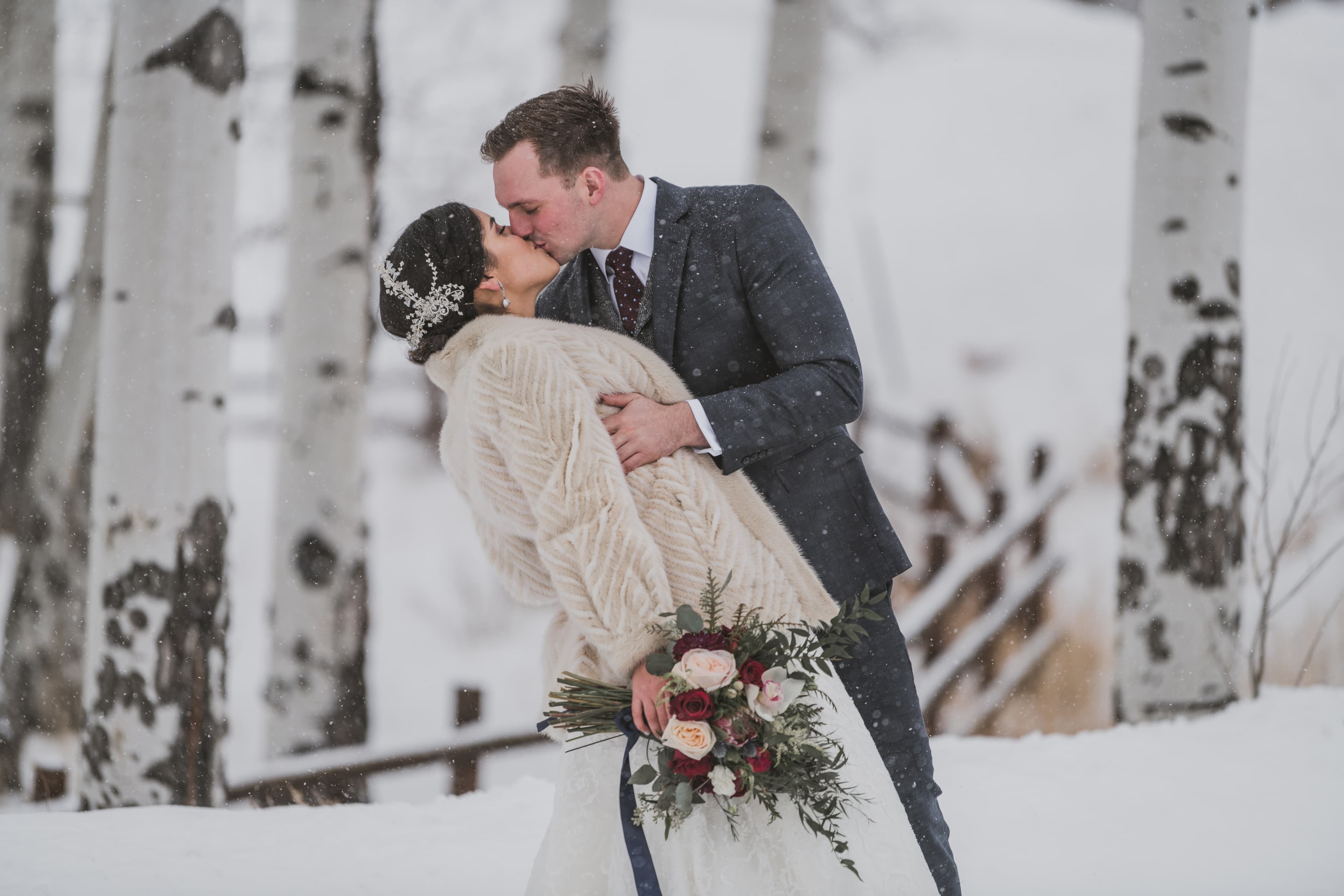 Sabrina and Patrick share their first kiss in the snow at their Alpino Vino wedding at 11,966 feet above Telluride, Colorado