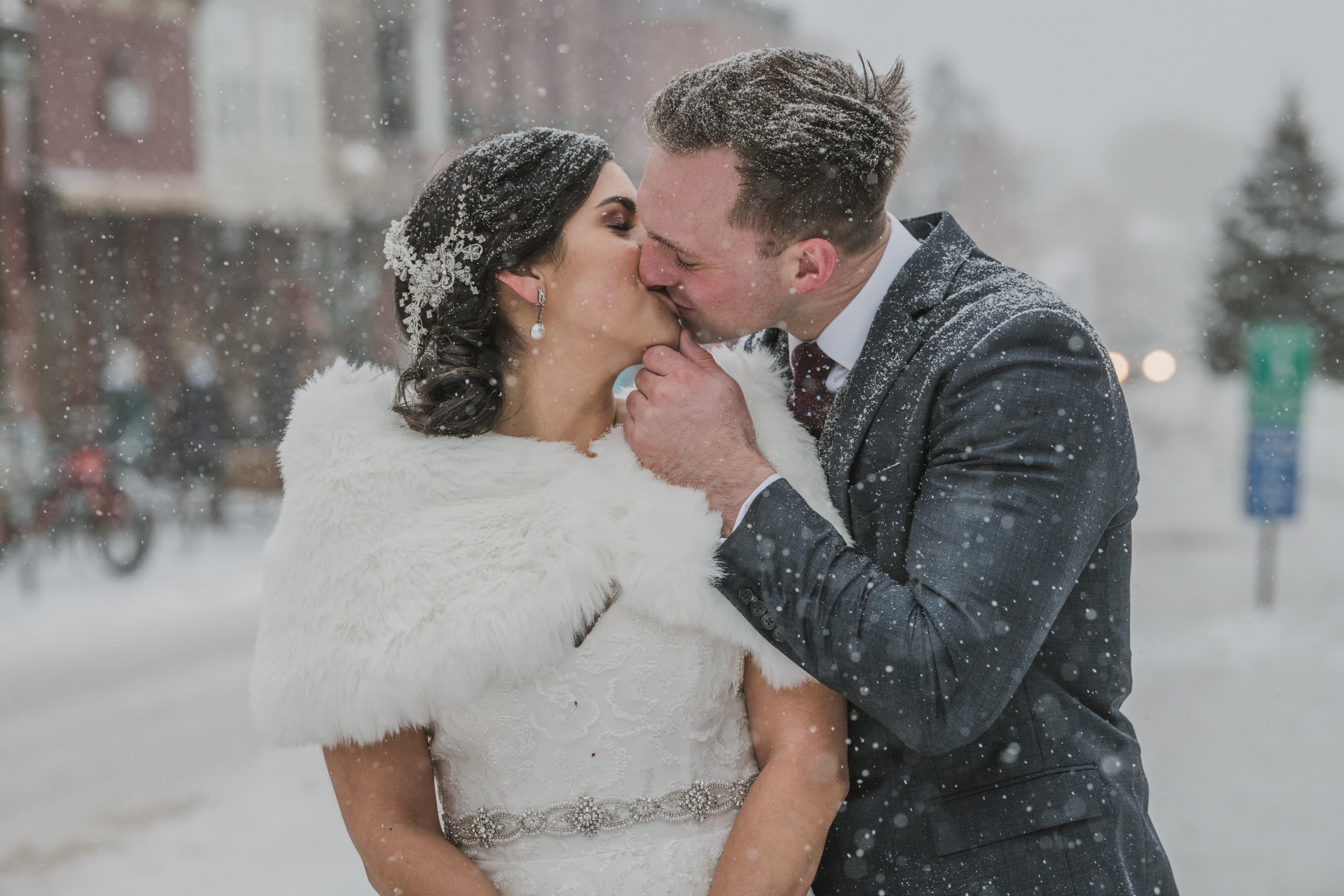 Sabrina and Patrick share a kiss as heavy snow falls around them on Telluride's main street
