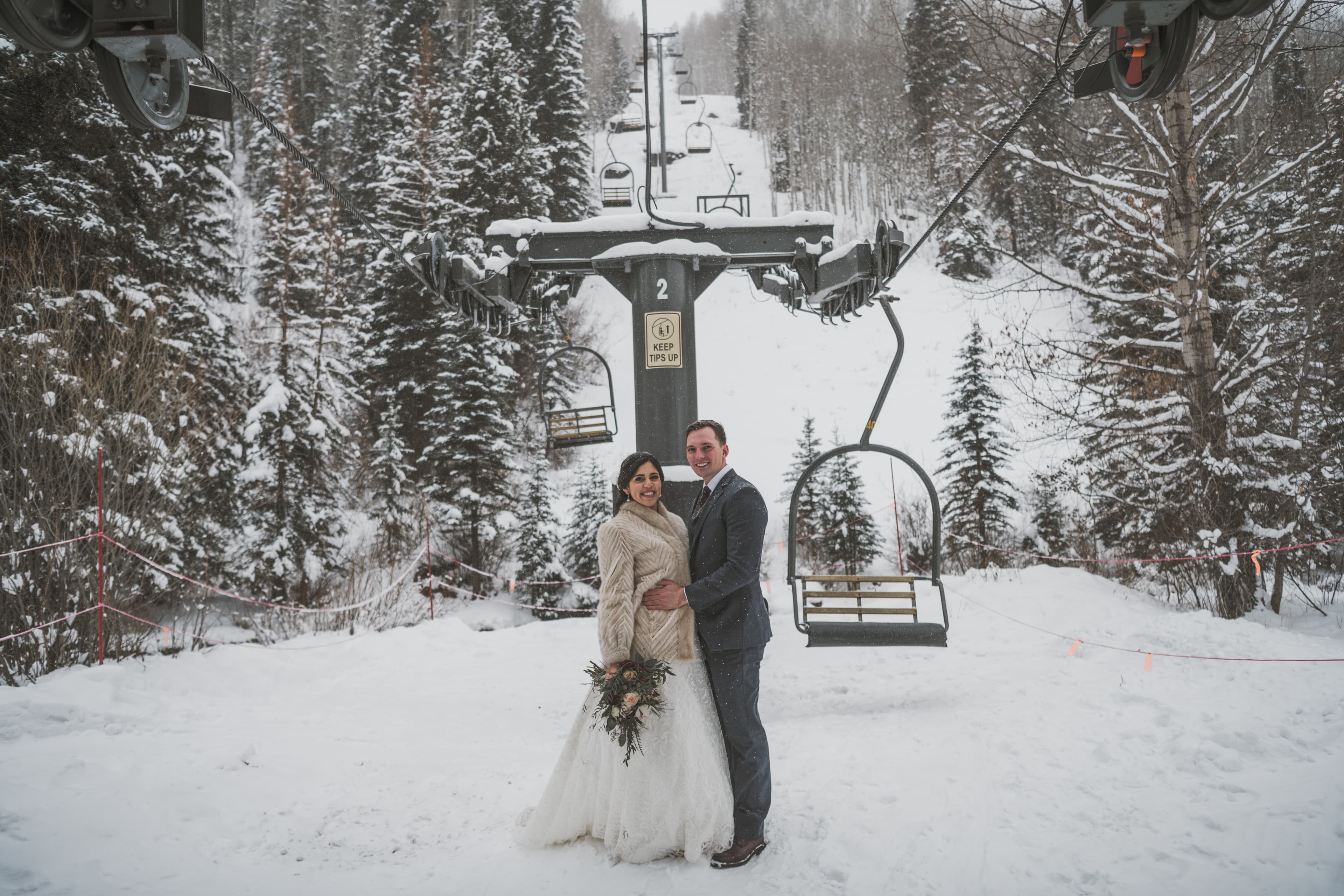 Sabrina and Patrick at the Telluride ski resort chairlift in winter
