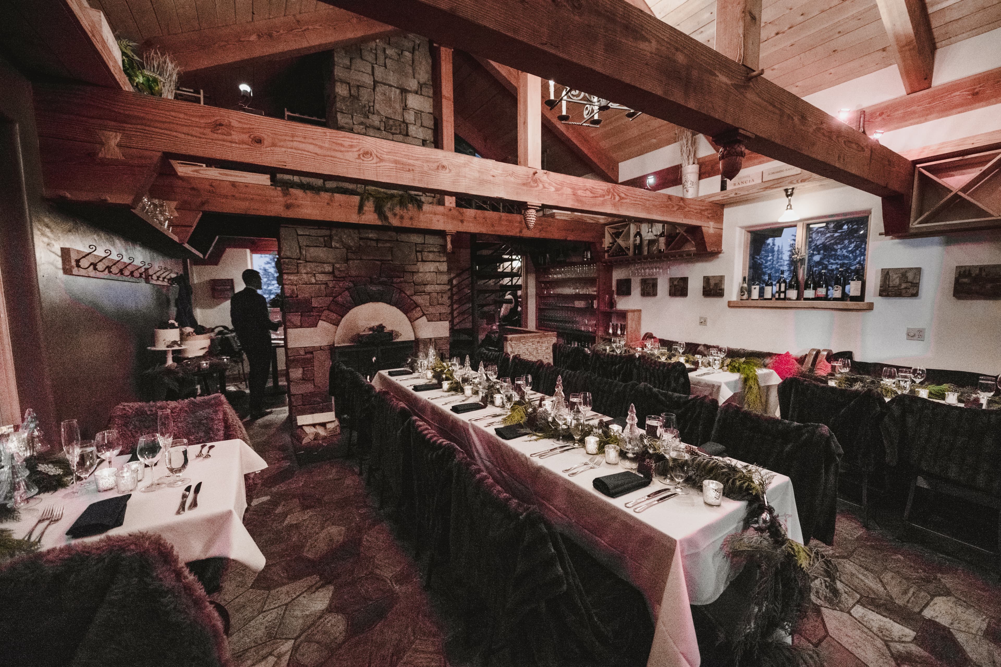 The intimate stone-and-timber dining room at Alpino Vino set for Sabrina and Patrick's reception