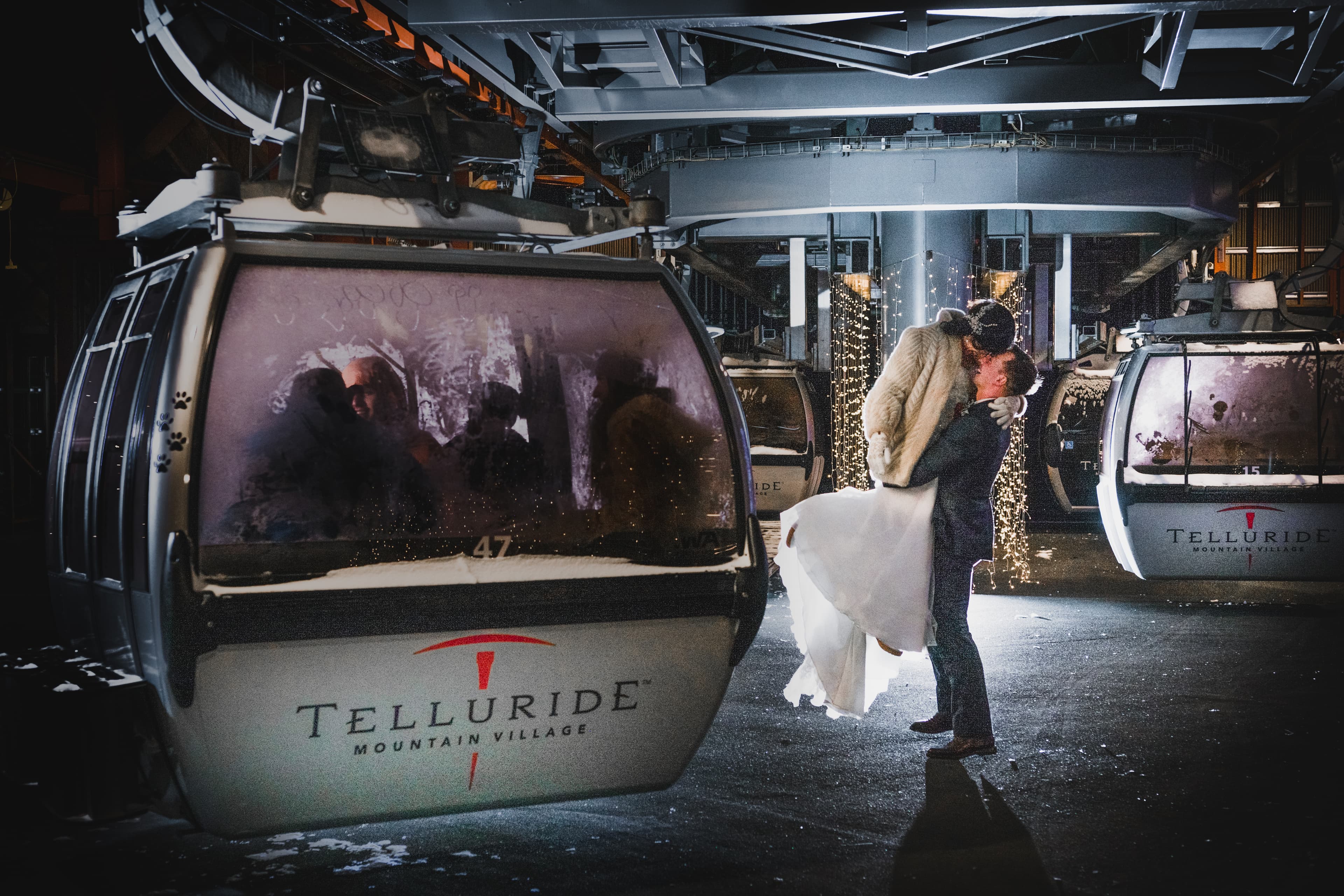 Sabrina and Patrick share a kiss in front of a Telluride Mountain Village gondola at the end of the night