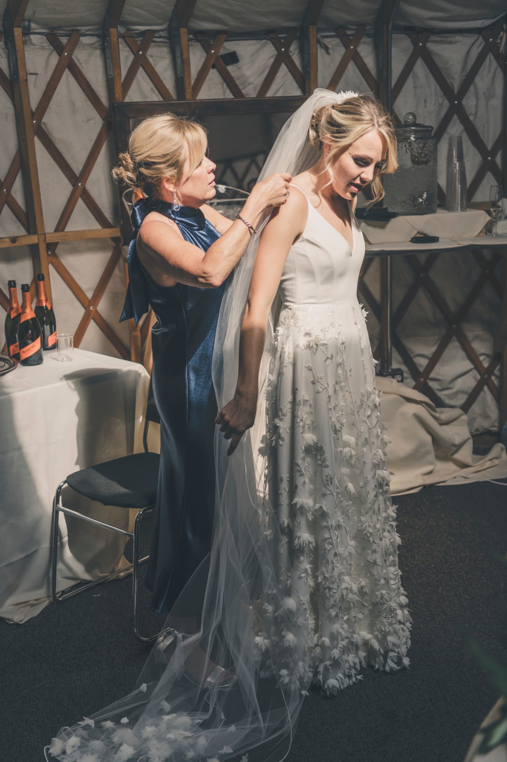 Meghan's mother helping her into her veil in the prep yurt at Gorrono Ranch