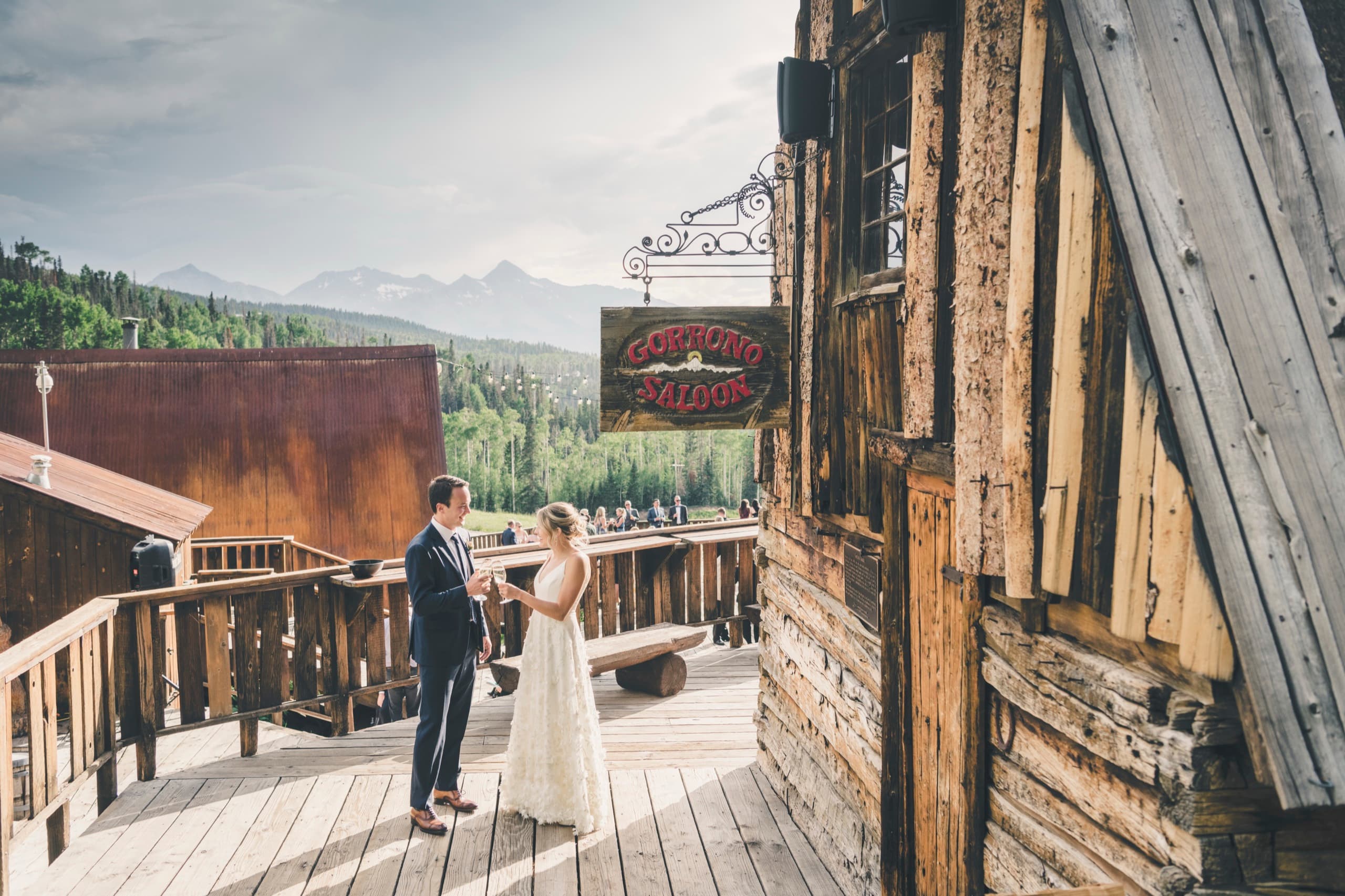 Meghan and Brent share a private moment under the Gorrono Saloon sign with distant Telluride peaks