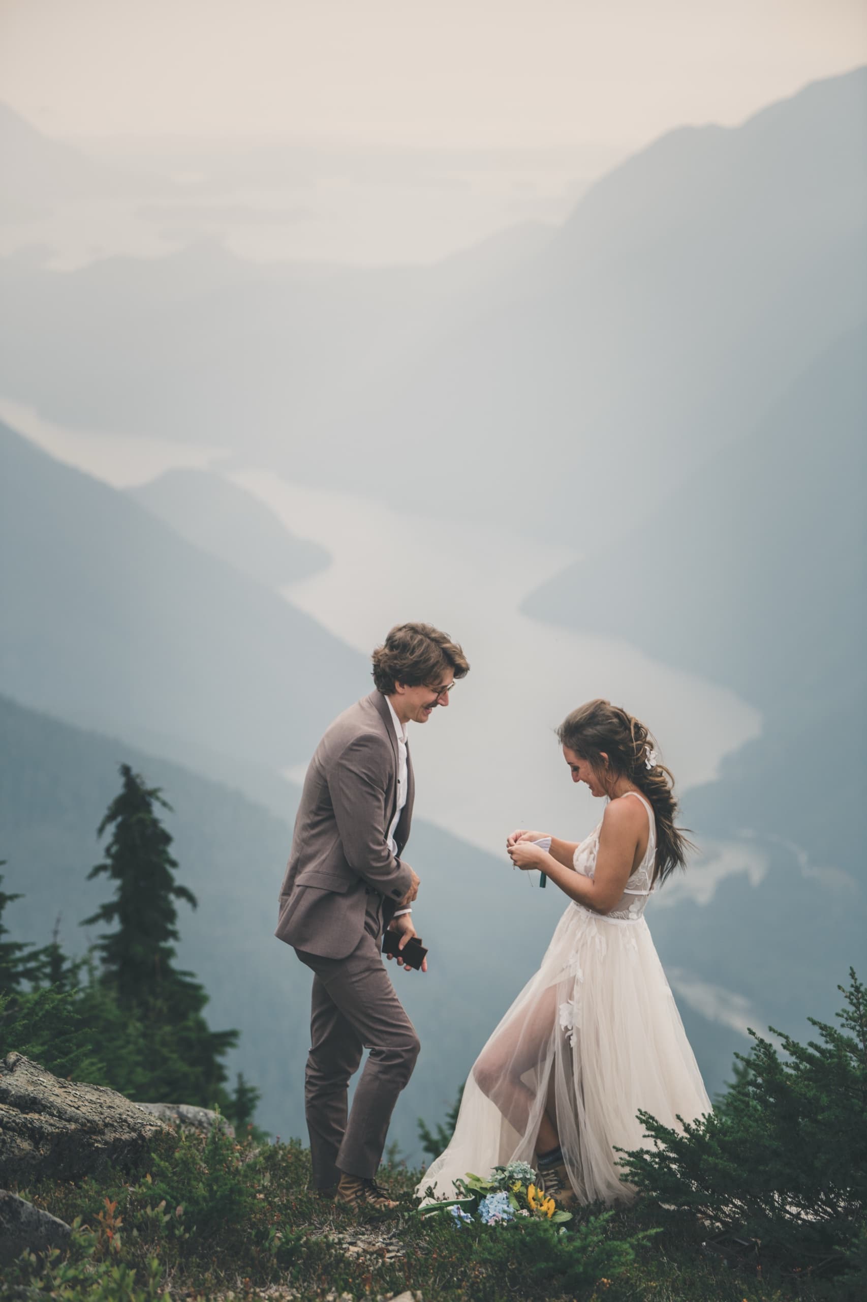 Rachel and Peter exchange vows on a mountaintop overlooking a foggy Tofino fjord