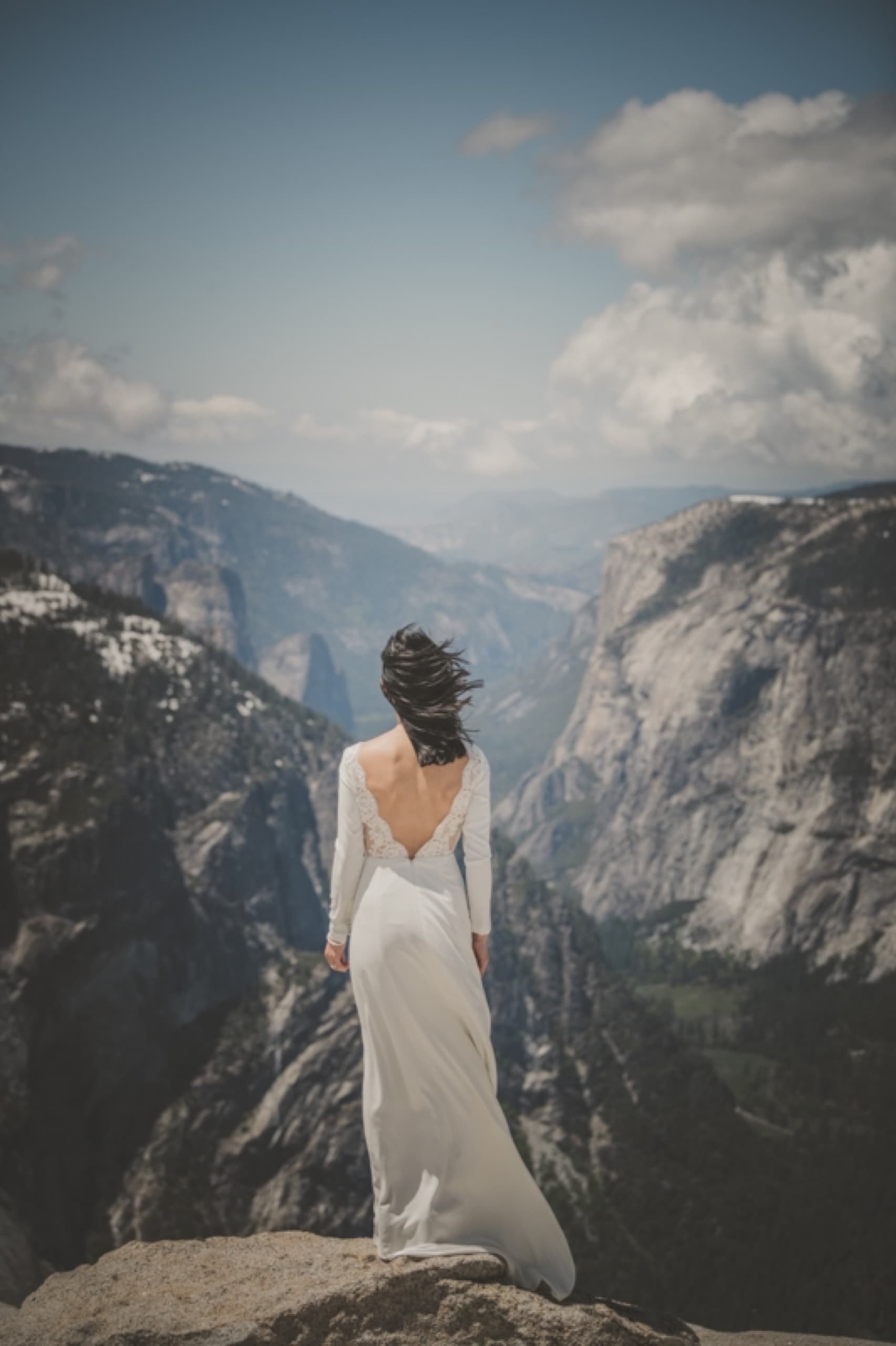 Bride looking out over a granite valley in Yosemite